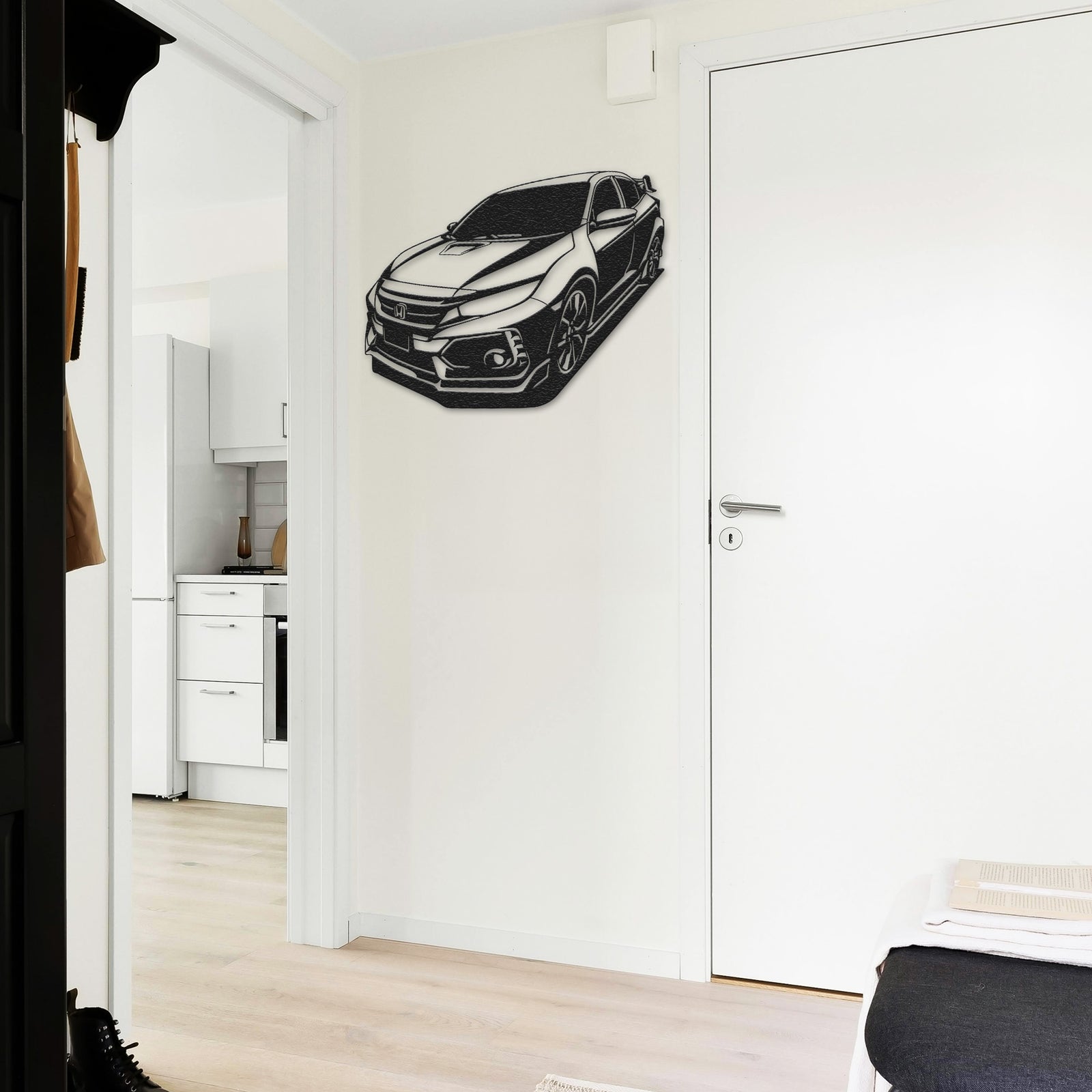 a black and white picture of a car on a wall