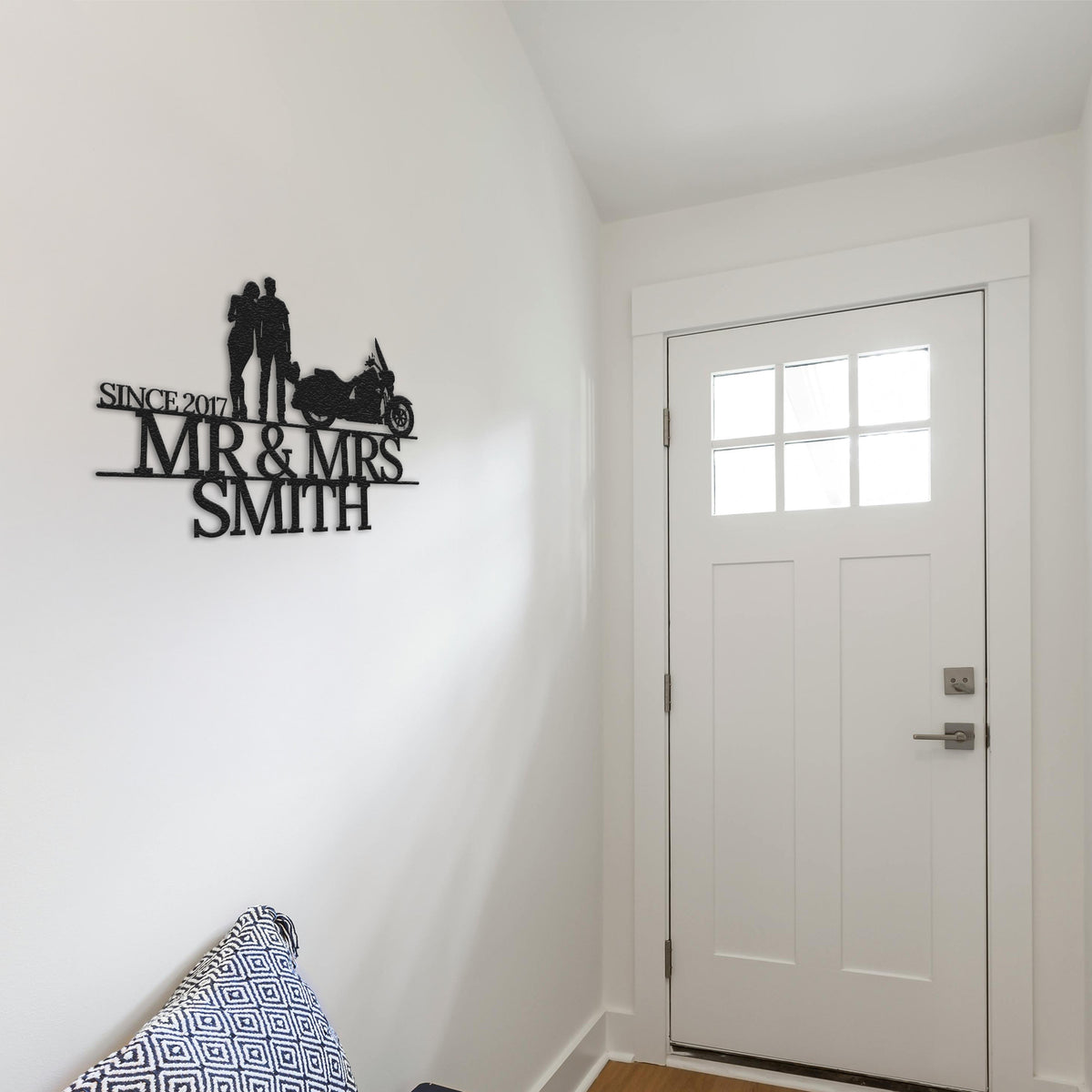 a white room with a white door and a black and white sign on the wall