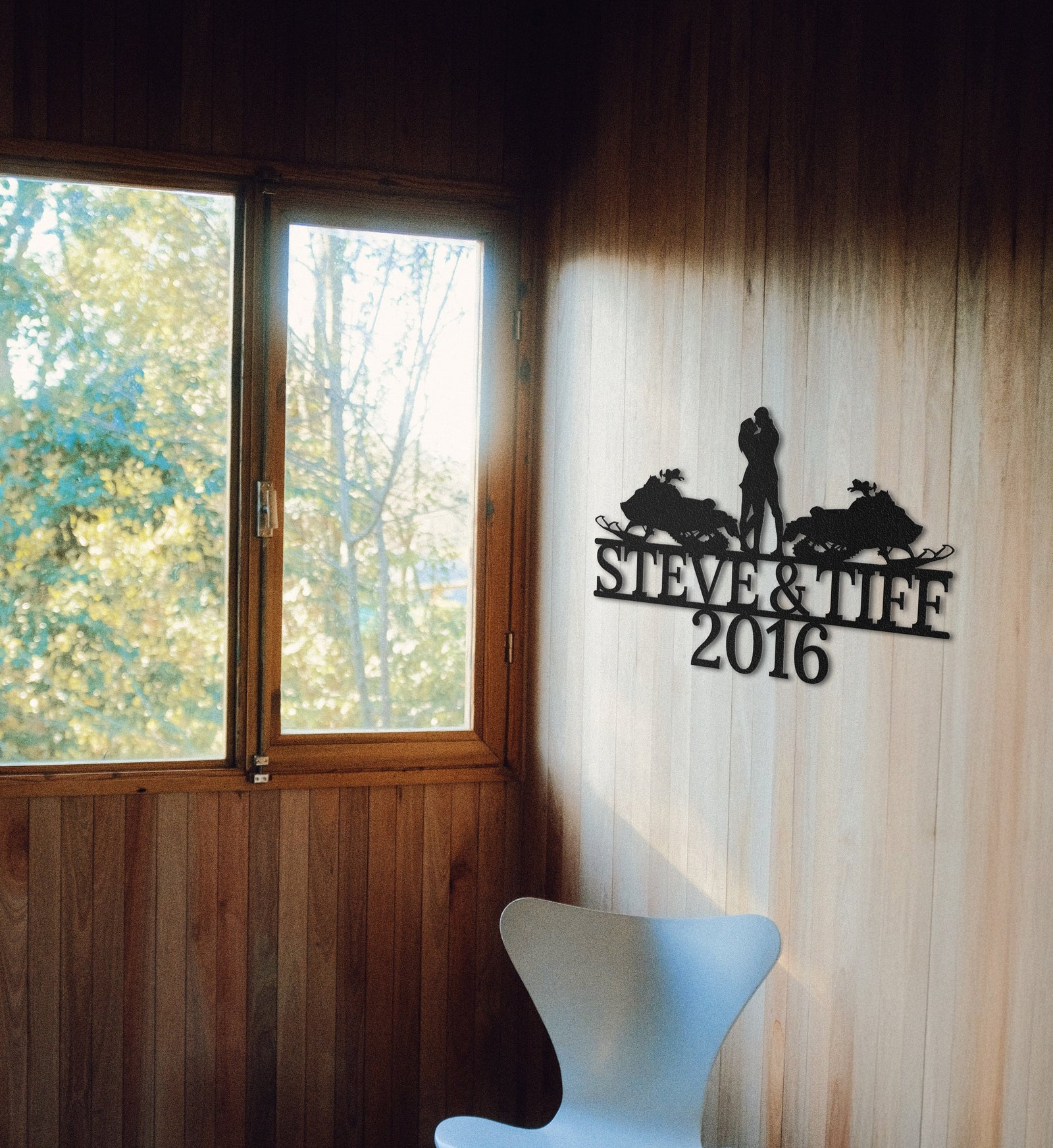 a white chair sitting next to a window in a room