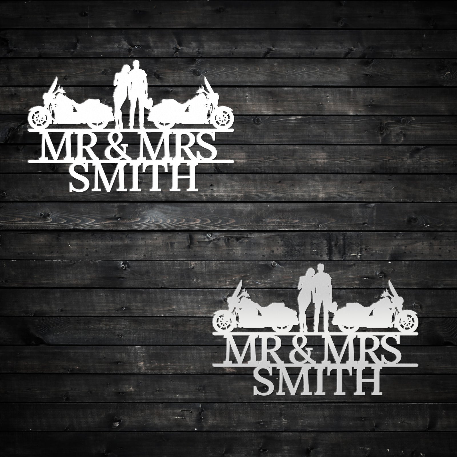 two metal wedding cake toppers on a wooden background
