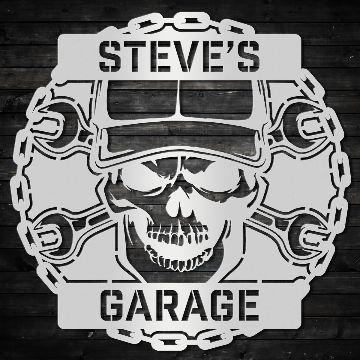 a skull wearing a helmet and wrenches with the words steve's garage