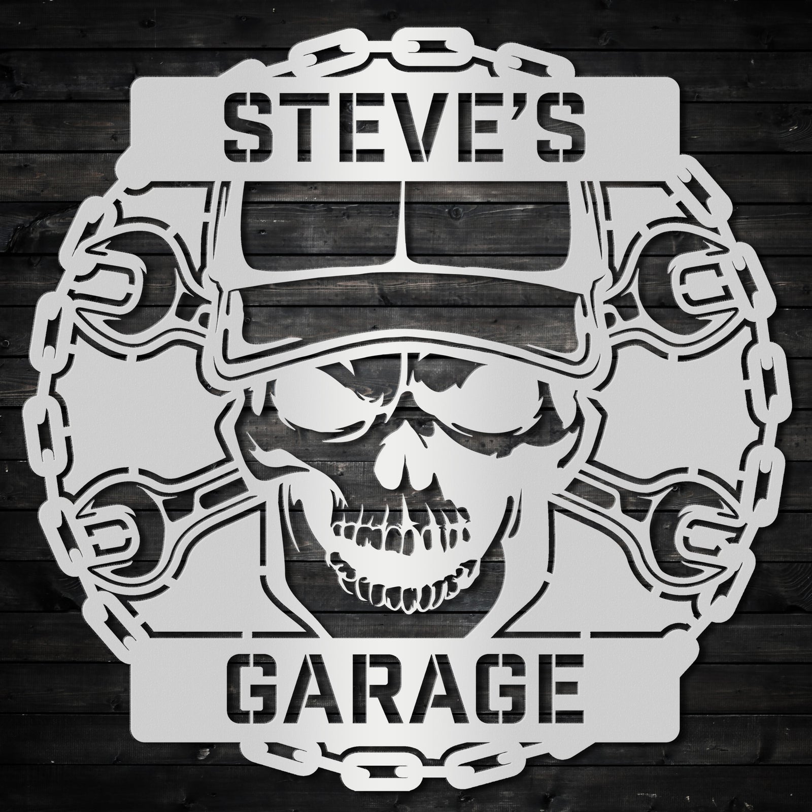 a skull wearing a helmet and wrenches with the words steve's garage