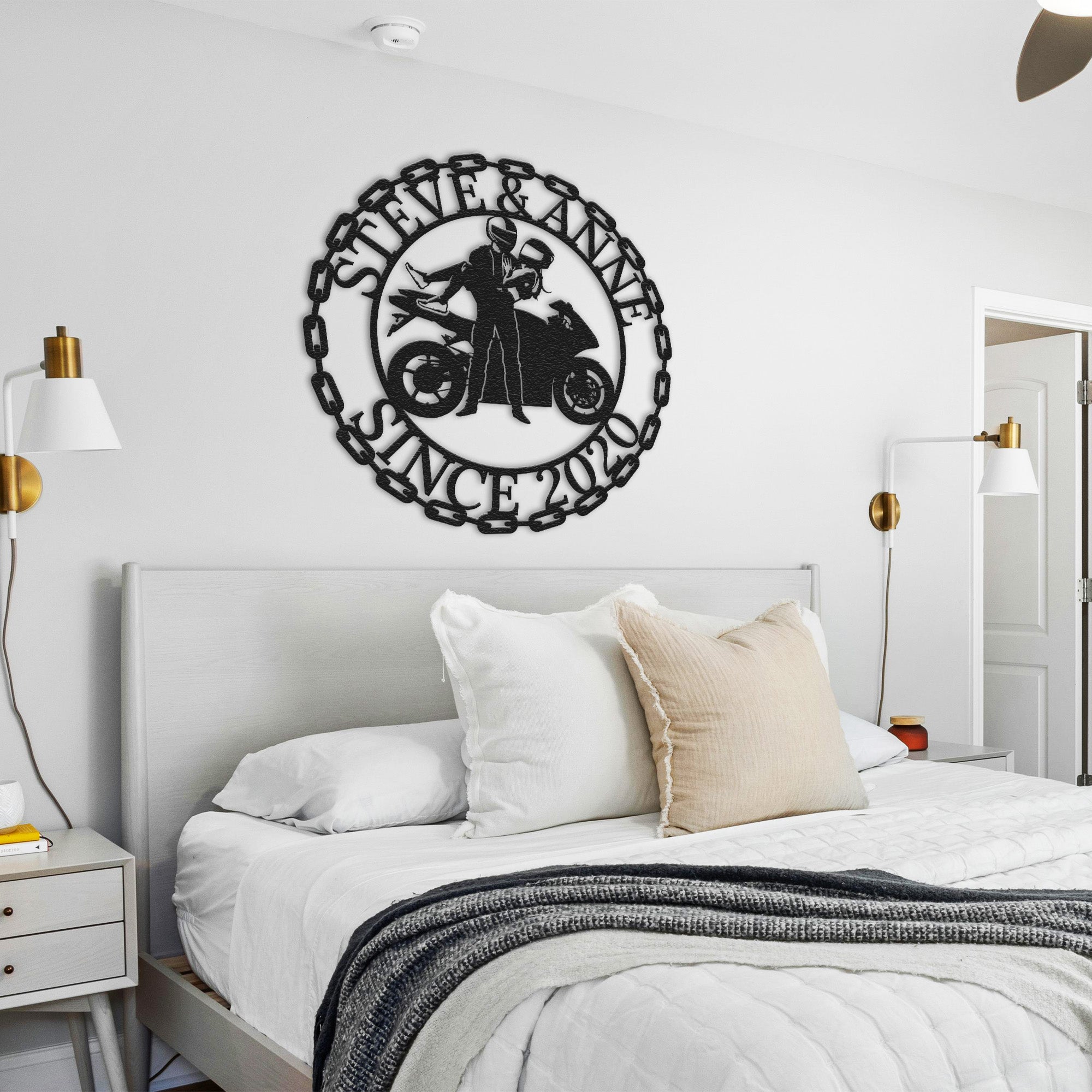 a bedroom with a white bed and a black and white clock on the wall